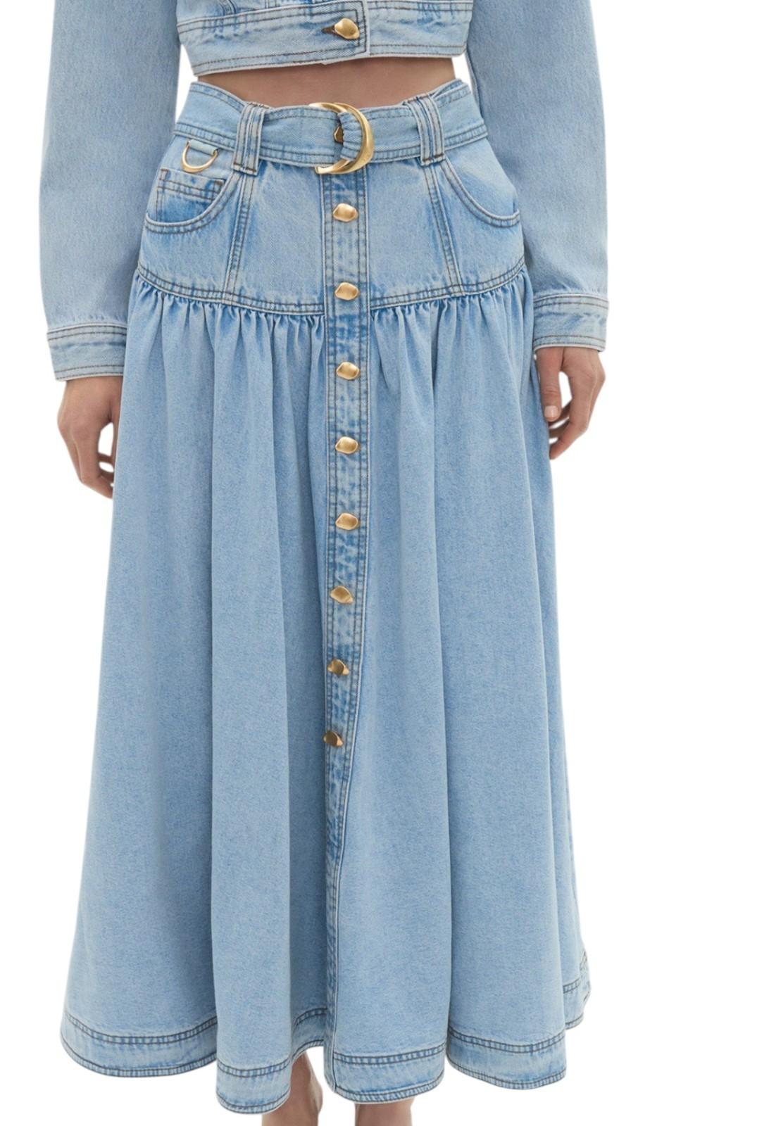 Light blue denim skirt with button details on a white background
