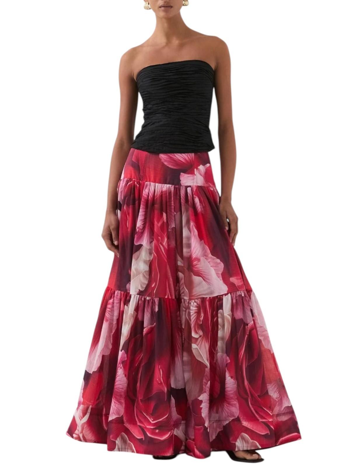 AI generated image of Woman wearing a black strapless top and red floral skirt on a white background