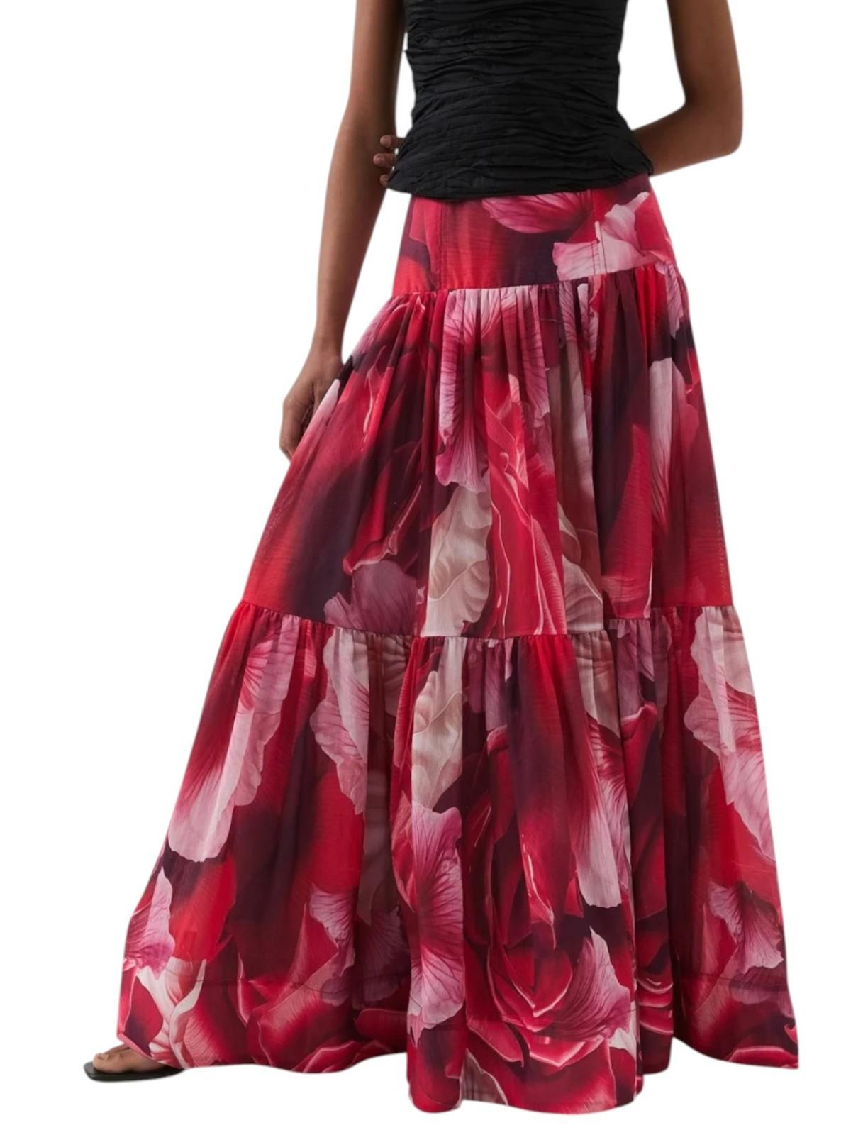 Red floral skirt worn by a person on a white background