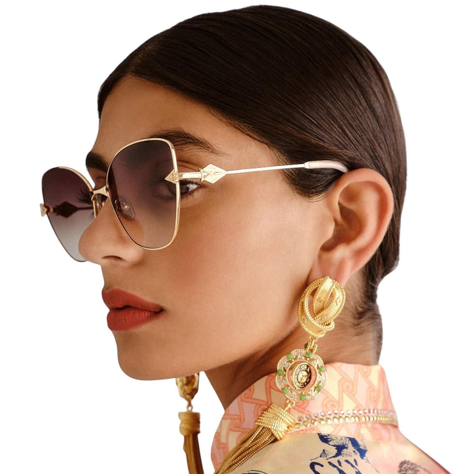 Naked Pear Camilla Desert Reign cat-eye sunglasses in gold and blush marble with grey gradient lenses on a model.