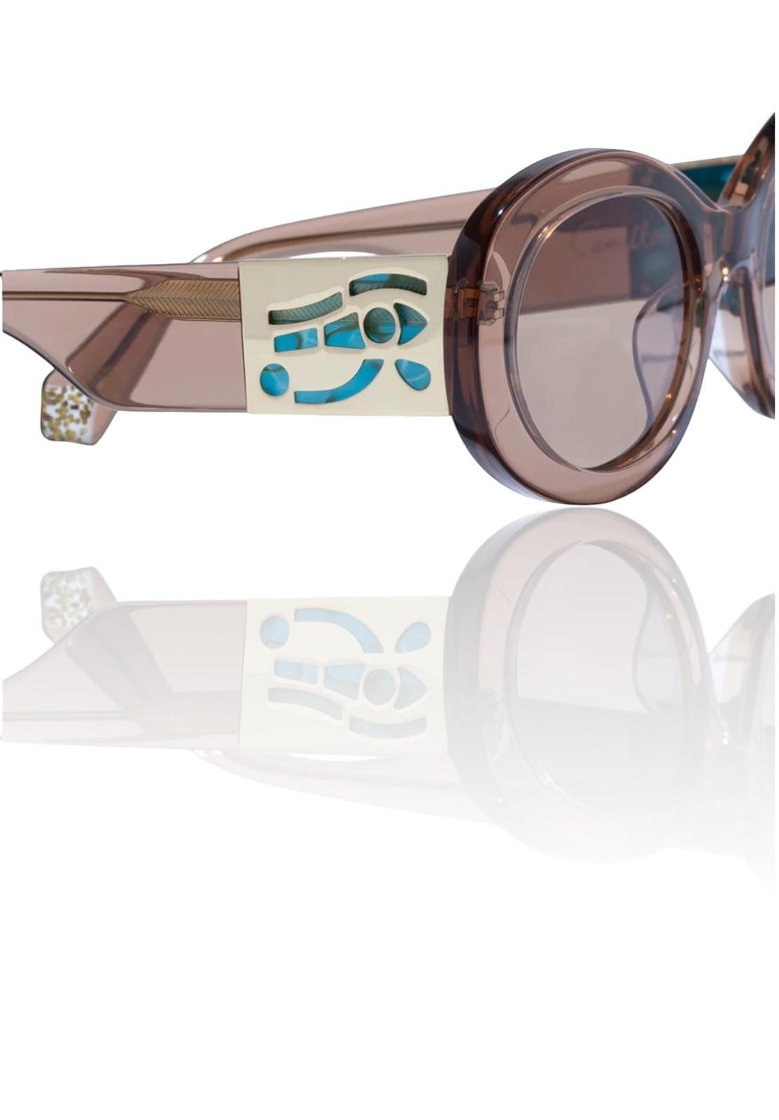 Naked Pear Camilla Sand Storm oval sunglasses in caramel acetate with gold Eye of Horus temple detail and brown lenses