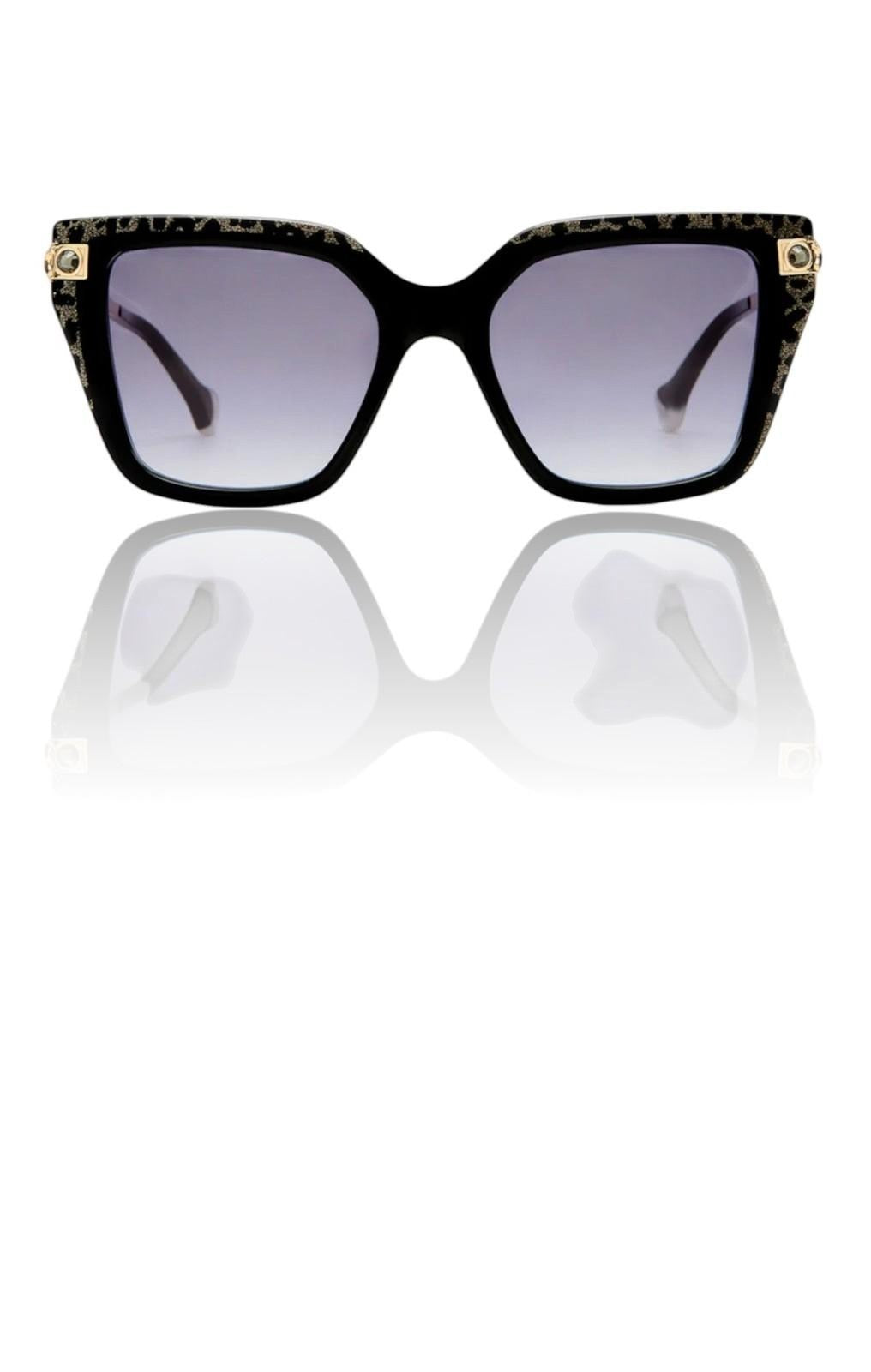 Naked Pear Camilla Here Comes Trouble cat eye sunglasses in black and gold glitter acetate with smoke gradient lenses.