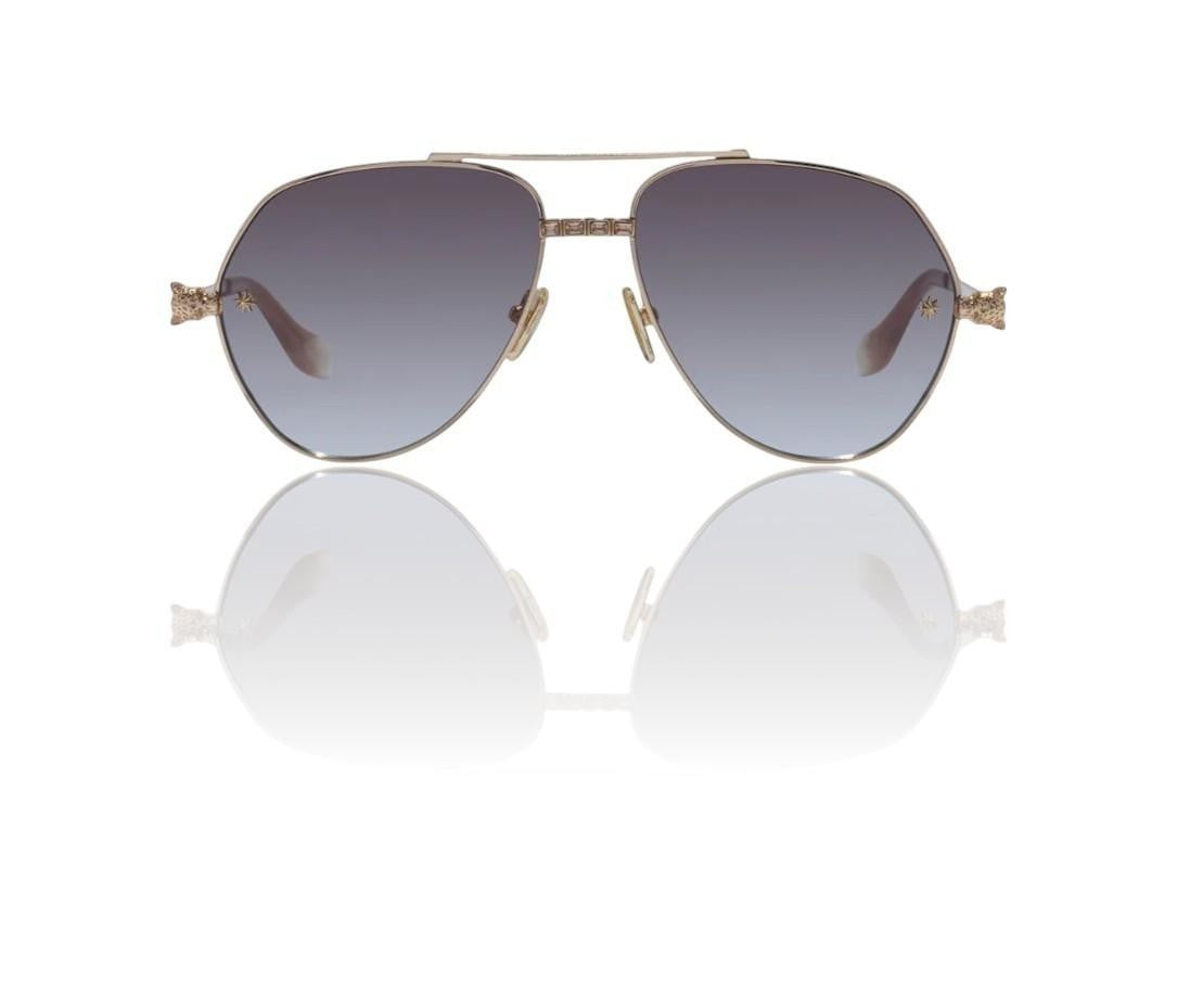 Naked Pear Camilla Nothing in Moderation gold aviator sunglasses with brown gradient lenses and green crystal accents.