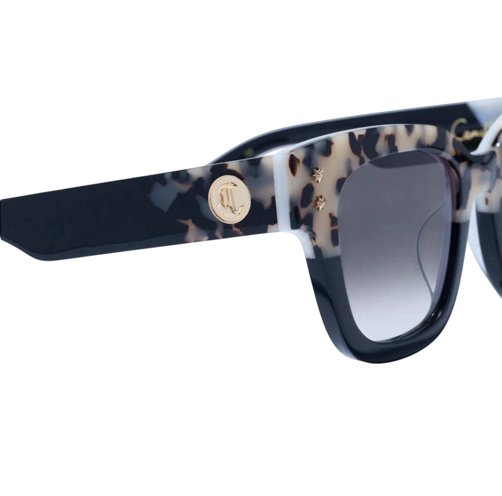Sunglasses with tortoiseshell frame and dark blue arms on a white background
