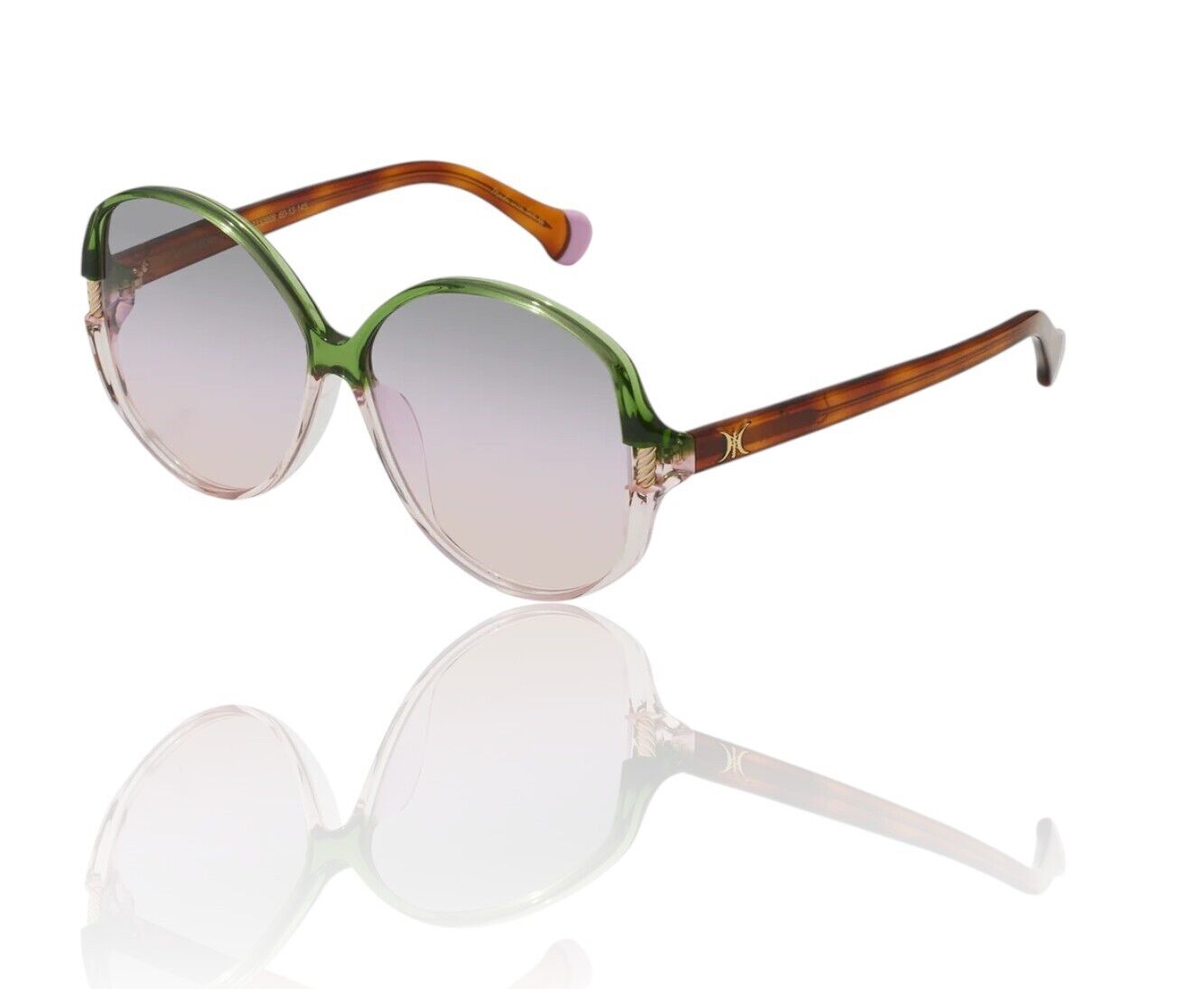 Oversized round sunglasses with a two-tone design featuring green and pink frames, tan arms, and gold eye detailing.