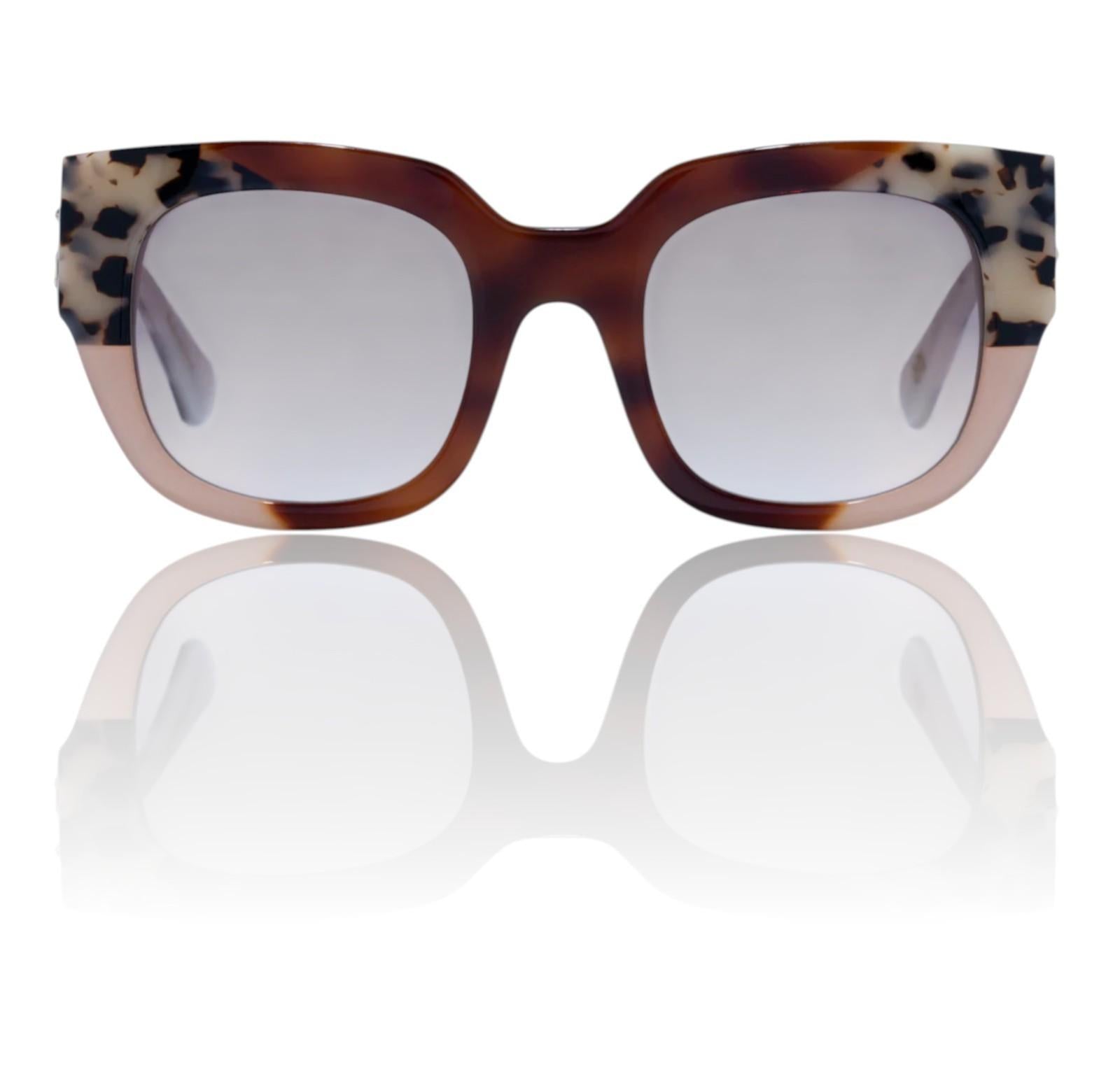 Sunglasses with tortoiseshell frame and reflective lenses on a white background