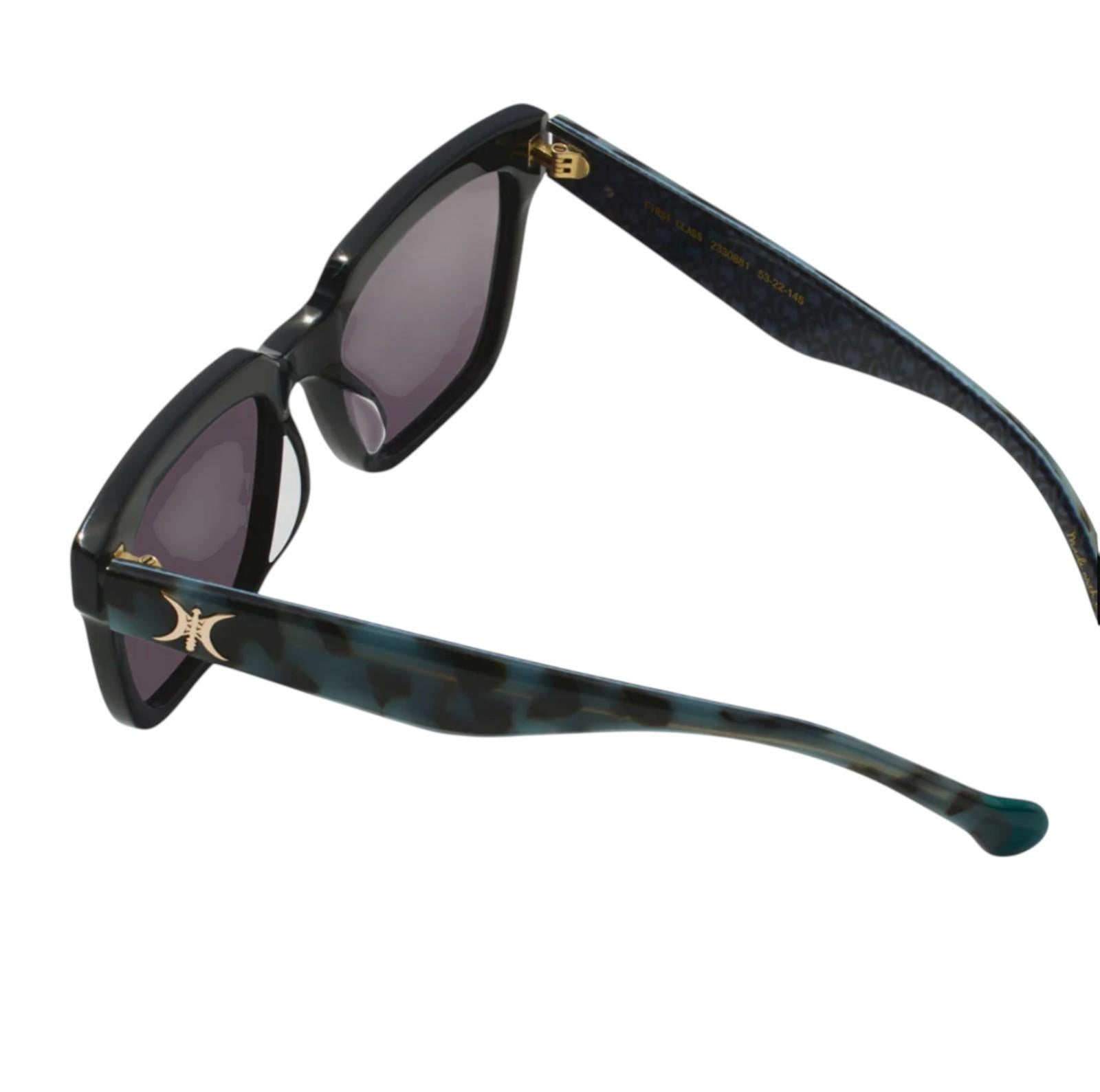 Sunglasses with a black and tortoiseshell frame on a white background