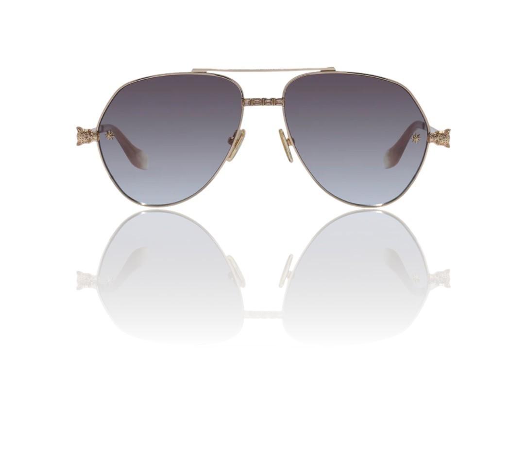 Sunglasses with gold frame and gradient lenses on a white background