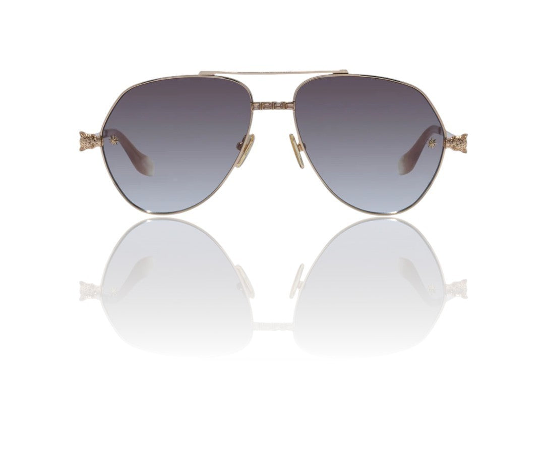 Sunglasses with gold frame and gradient lenses on a white background