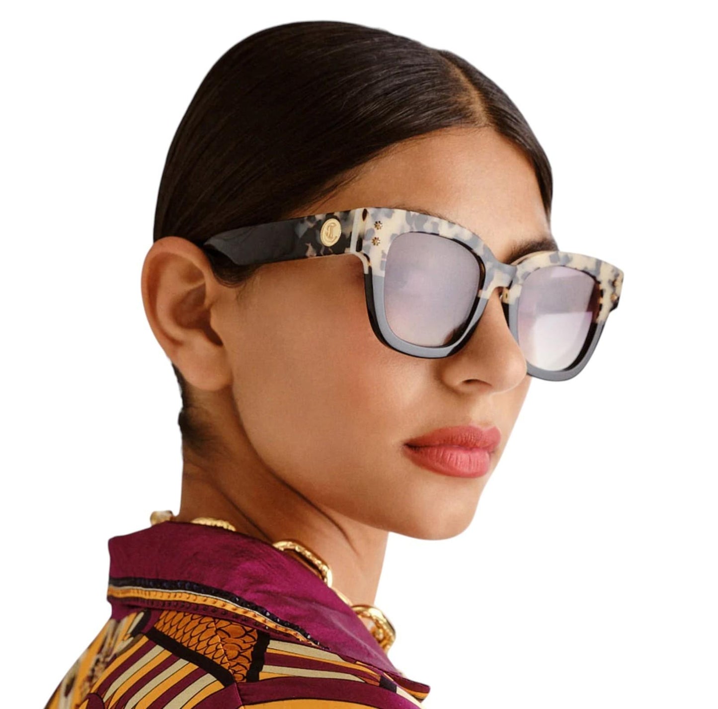 Woman wearing a patterned headscarf and sunglasses on a white background