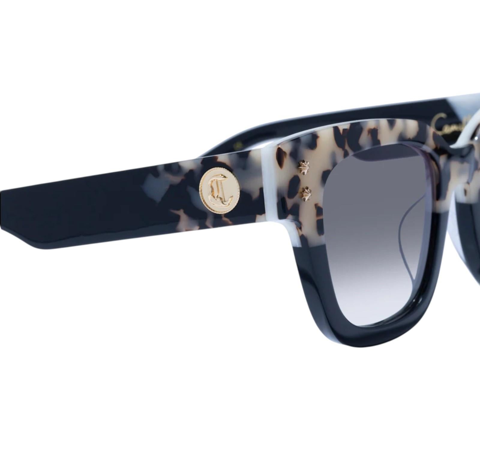 Sunglasses with tortoiseshell frame and dark blue arms on a white background