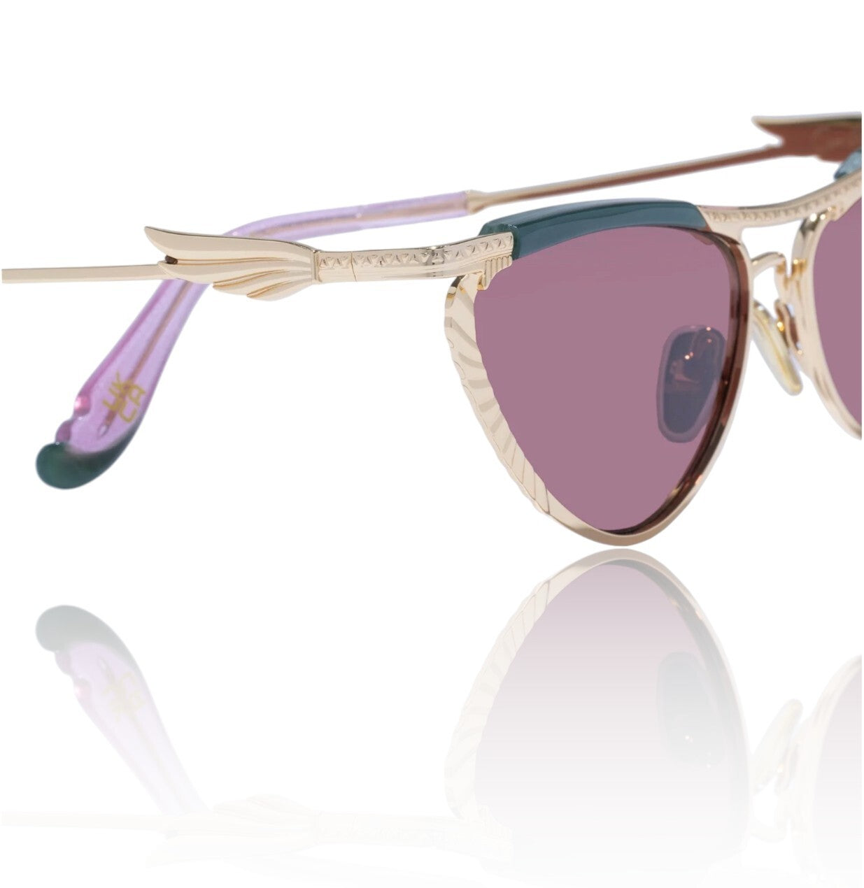 Sunglasses with gold frame and pink lenses on a white background