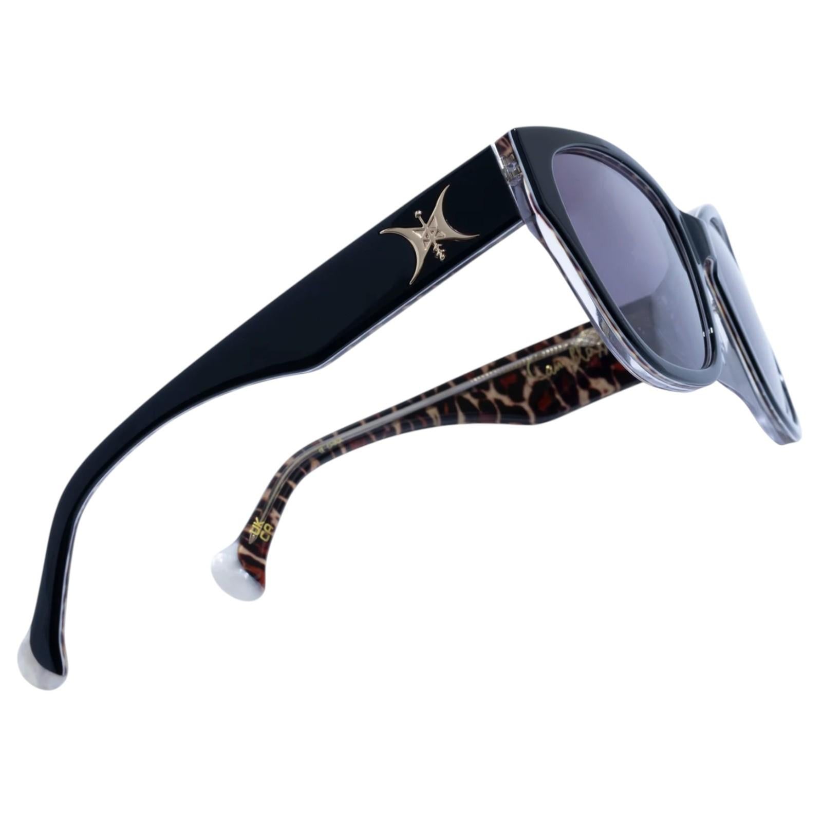 Sunglasses with black and leopard print arms on a white background