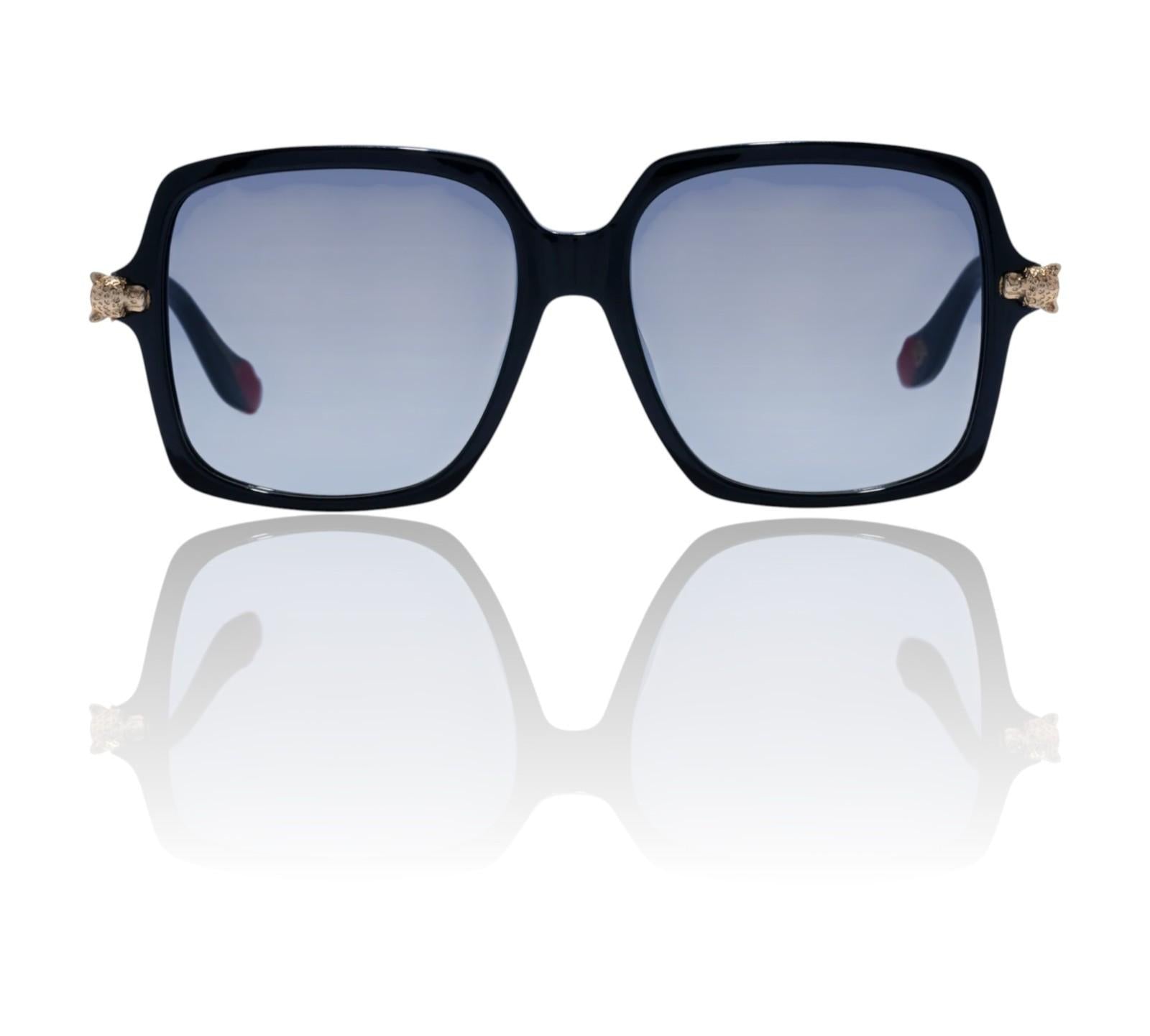 Black sunglasses with gold accents on a white background