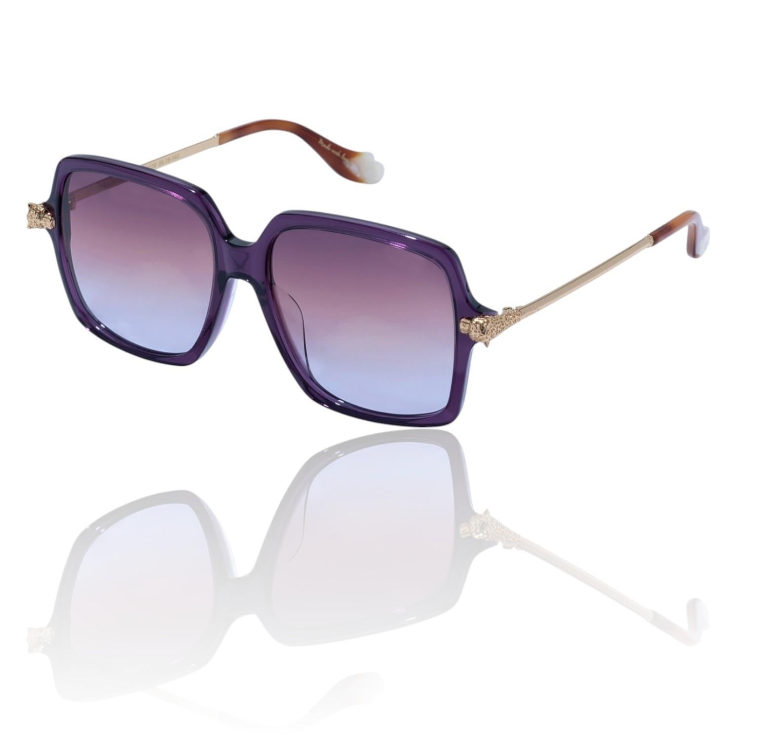 Sunglasses with purple gradient lenses and gold accents on a white background