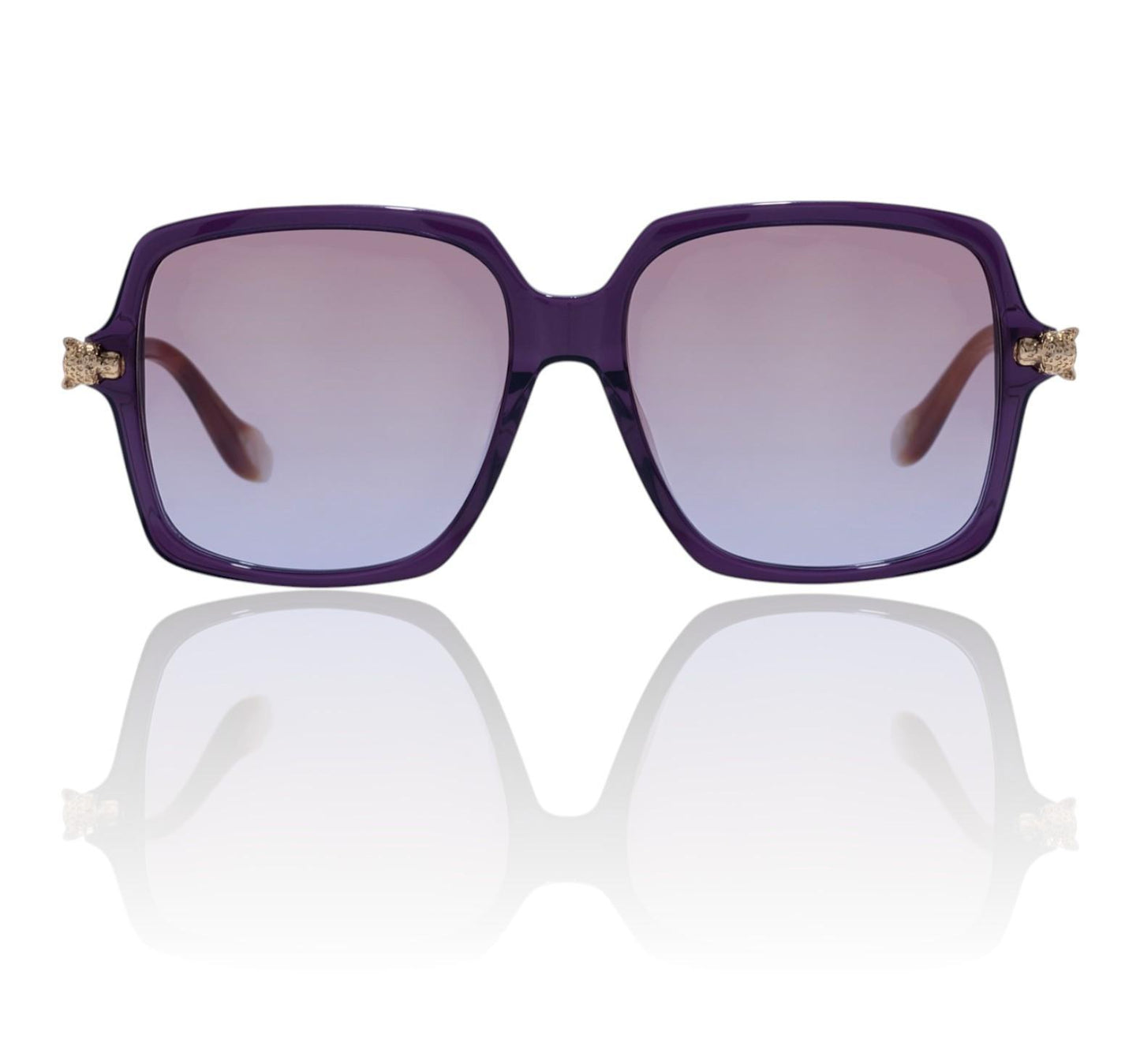 Purple sunglasses with gold accents on a reflective white surface