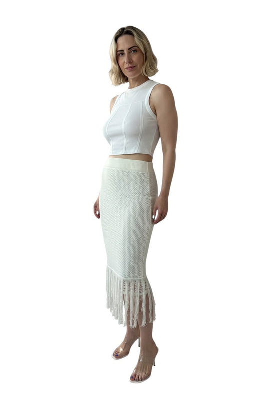 Woman wearing a white top and skirt set on a white background