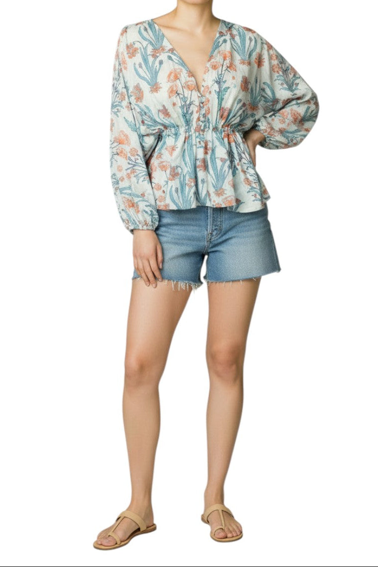 AI generated image of Woman wearing a floral blouse and denim shorts on a white background