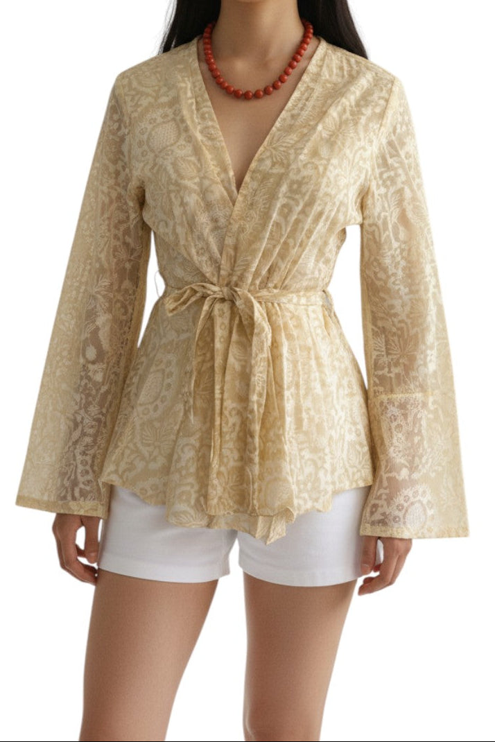 AI generated image of Woman wearing a beige patterned top with a tie waist and white shorts on a white background