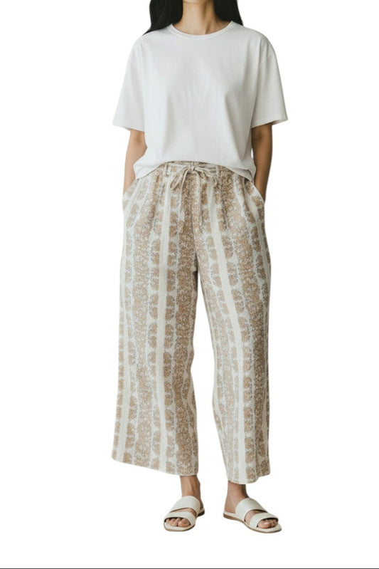AI generated image of Woman wearing a white t-shirt and patterned pants on a white background