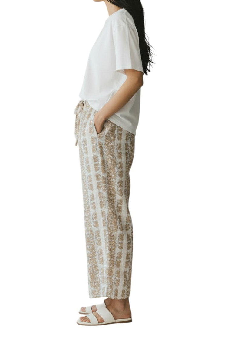 AI generated image of Person wearing a white t-shirt and patterned pants on a white background