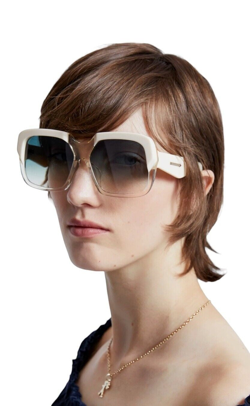Model wearing Naked Pear Karen Walker Asscher oversized ivory bio-acetate sunglasses with green-gradient lenses
