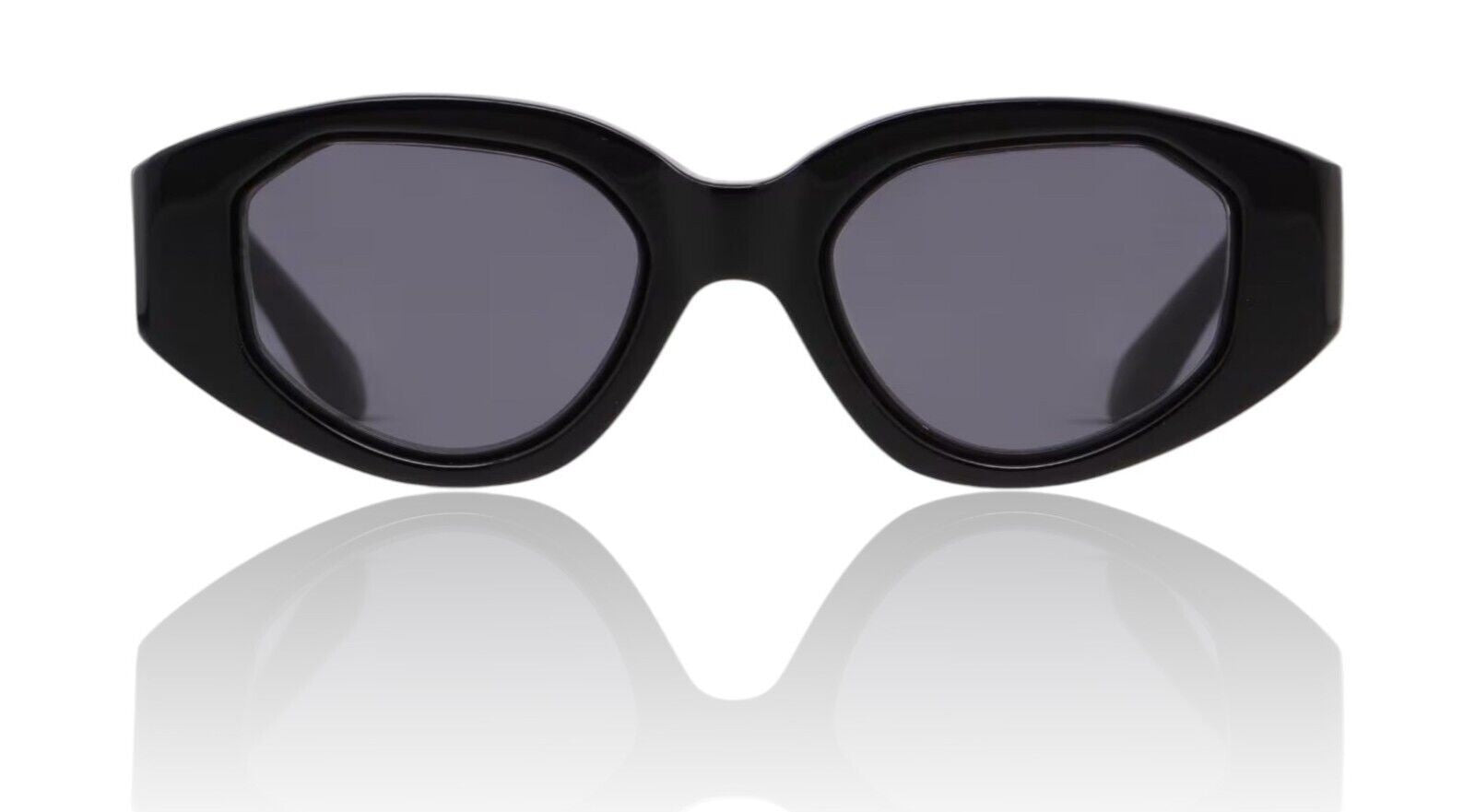 Naked Pear Karen Walker Castaway sunglasses featuring a black oval acetate frame with angular details and grey lenses.