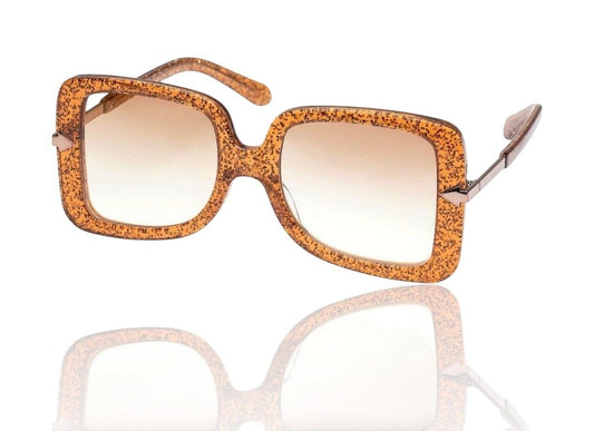 Naked Pear Karen Walker Eden sunglasses in supernova glitter acetate with oversize D-frame and brown gradient lenses.