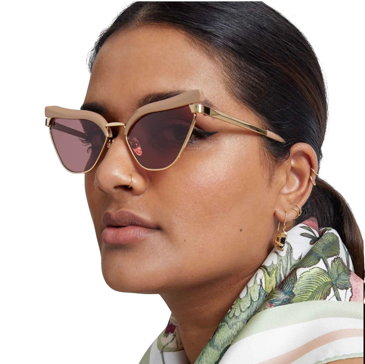 Naked Pear Karen Walker Fantasia cat-eye sunglasses with taupe acetate, gold metal, and maroon lenses on a model