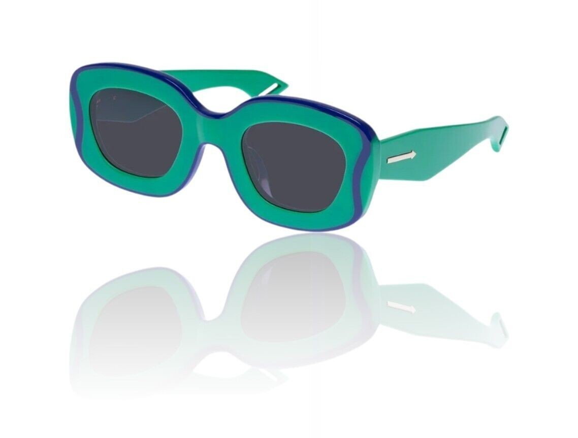 Naked Pear Karen Walker Field Trip sunglasses in grasshopper green acetate with blue wavy rim and smoke lenses.