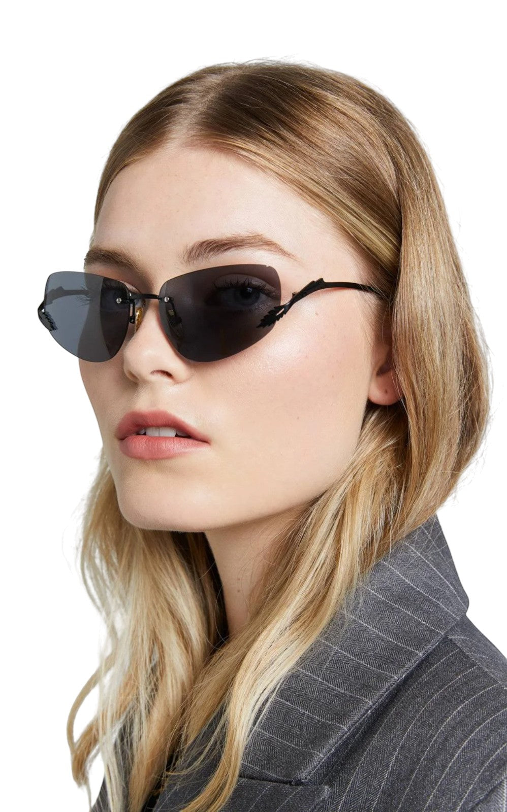 Model wearing Naked Pear Karen Walker Fleur rimless sunglasses with black Monel frames and grey mono lenses