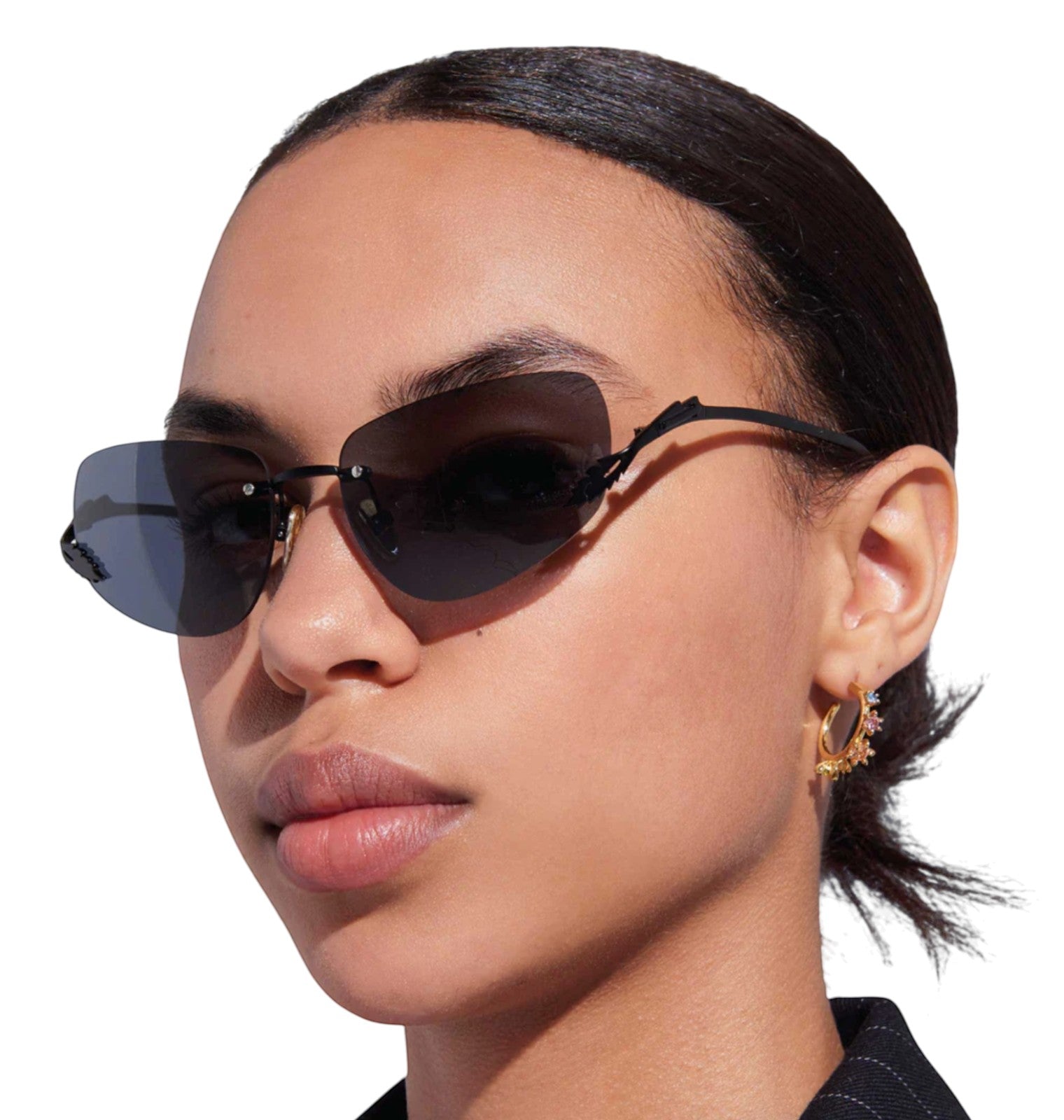 Model wearing Naked Pear Karen Walker Fleur rimless sunglasses with black metal frames and grey mono lenses