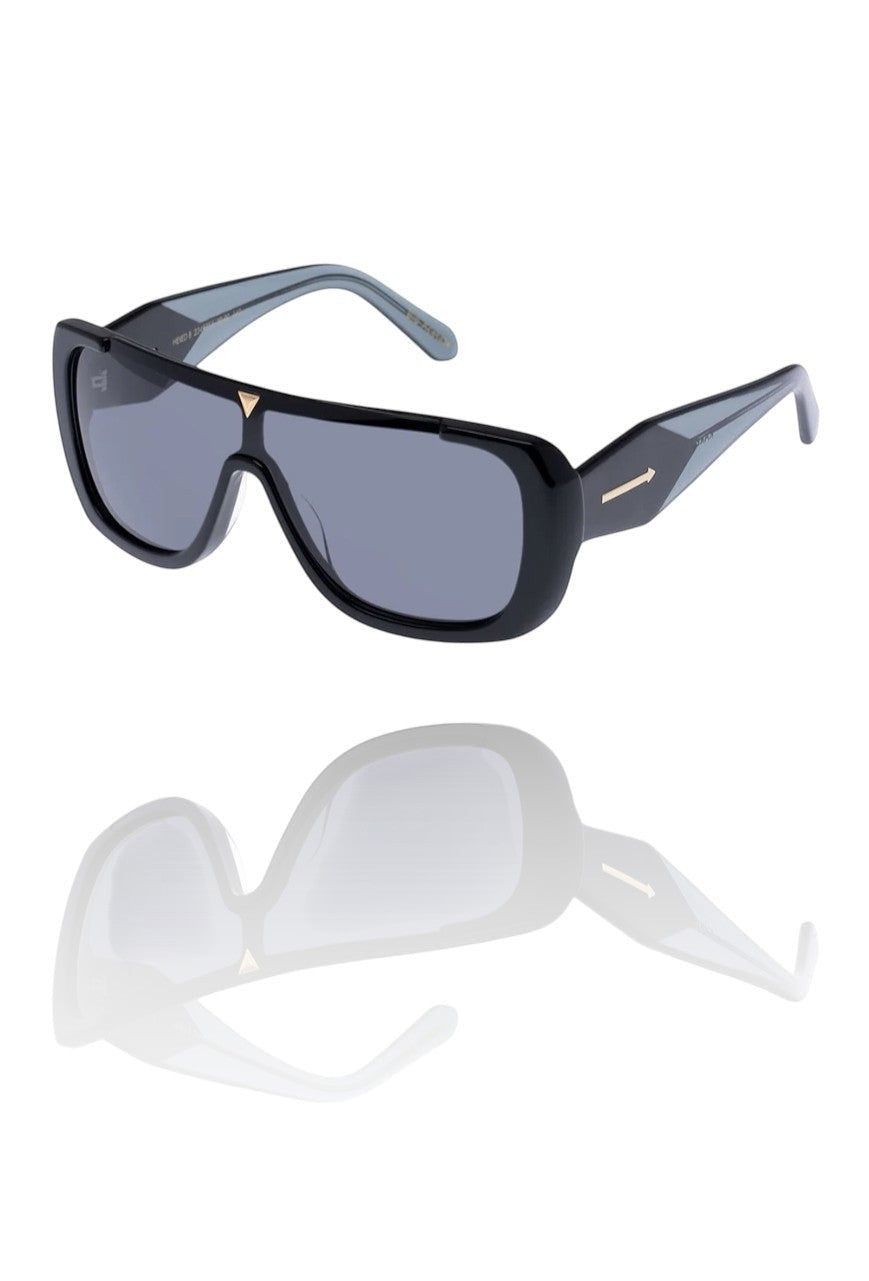 Naked Pear Karen Walker Hexed B sunglasses featuring a black bio-acetate shield frame with smoke lenses and gold accents.