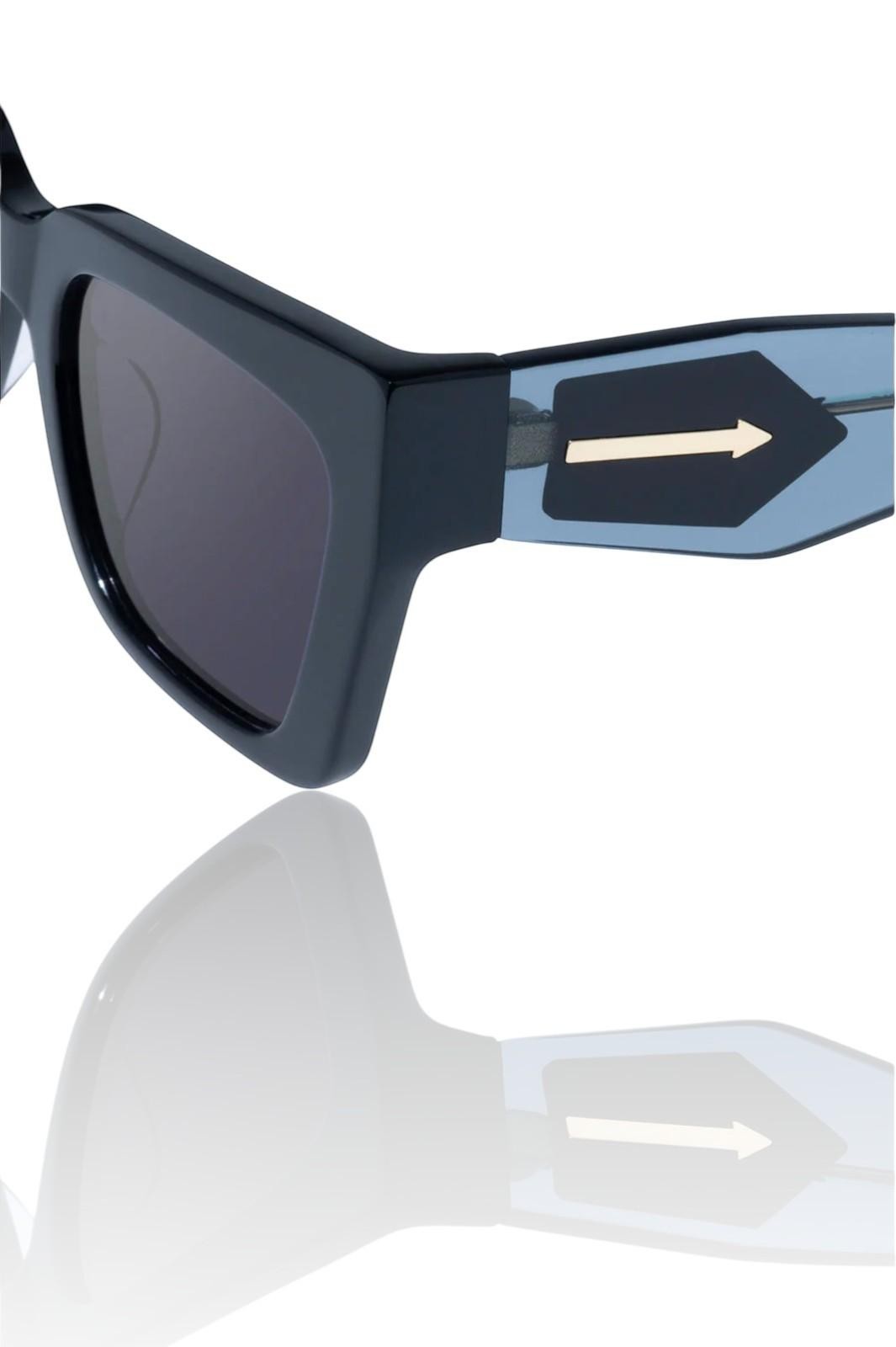 Naked Pear Karen Walker Immortalised square cat-eye sunglasses in black bio-acetate with blue arms and gold arrow logo.