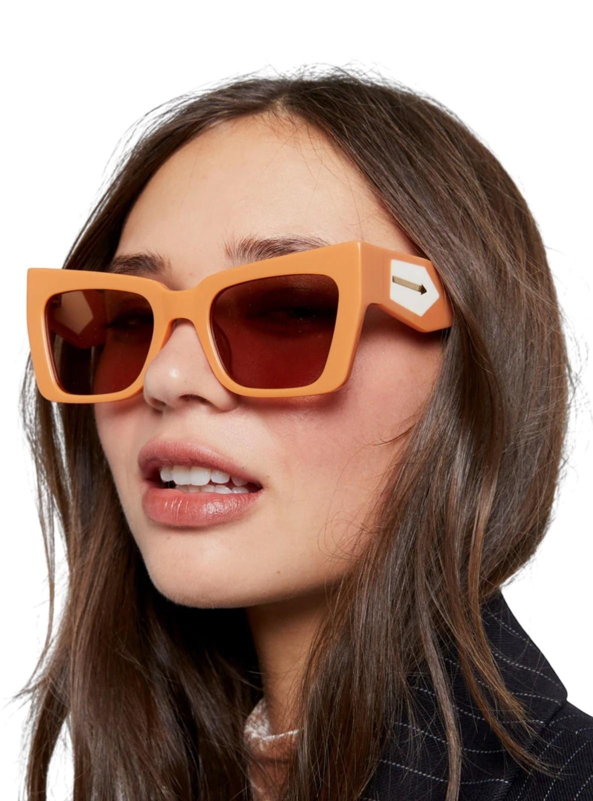 Model wearing Naked Pear Karen Walker Immortalised square cat-eye sunglasses in Italian clay with ivory accents