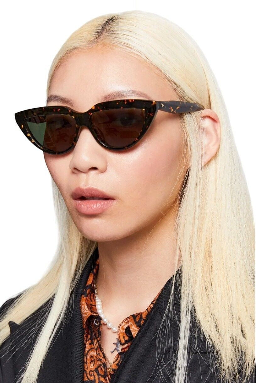 Naked Pear Karen Walker Lash Splash cat-eye sunglasses in cracked tortoise shell with green lenses on a blonde model