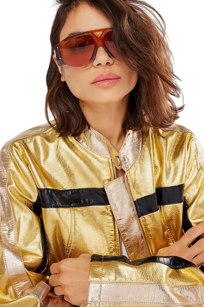 Model wearing Naked Pear Karen Walker Marquise oversized aviator sunglasses in sunset acetate with persimmon lenses