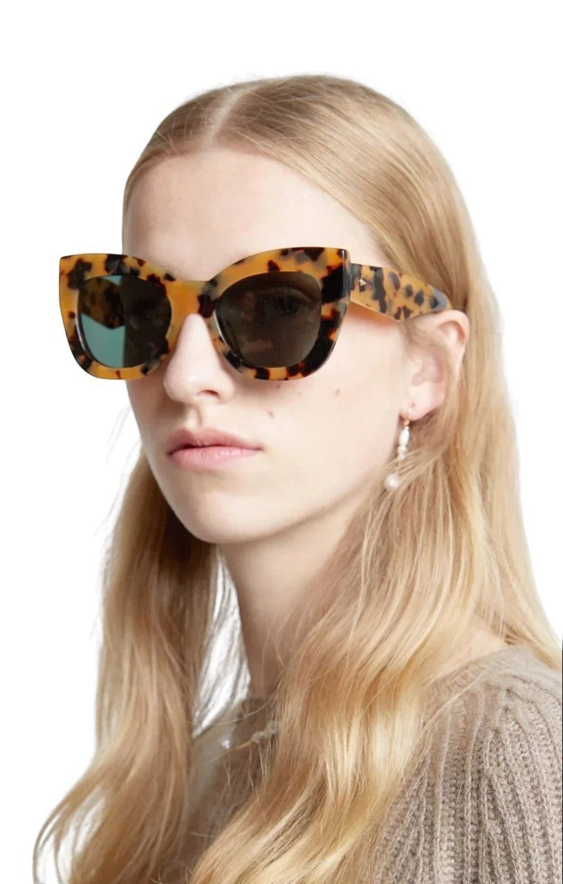 Naked Pear Karen Walker Northern Lights cat-eye sunglasses in tortoise shell acetate with green lenses on a model