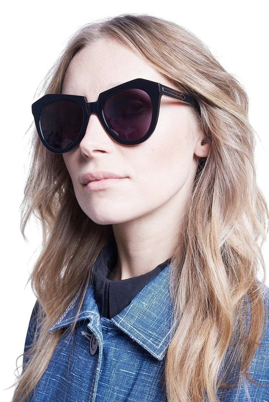 Model wearing Naked Pear Karen Walker Number One black bio-acetate cat-eye sunglasses with grey smoke mono lenses