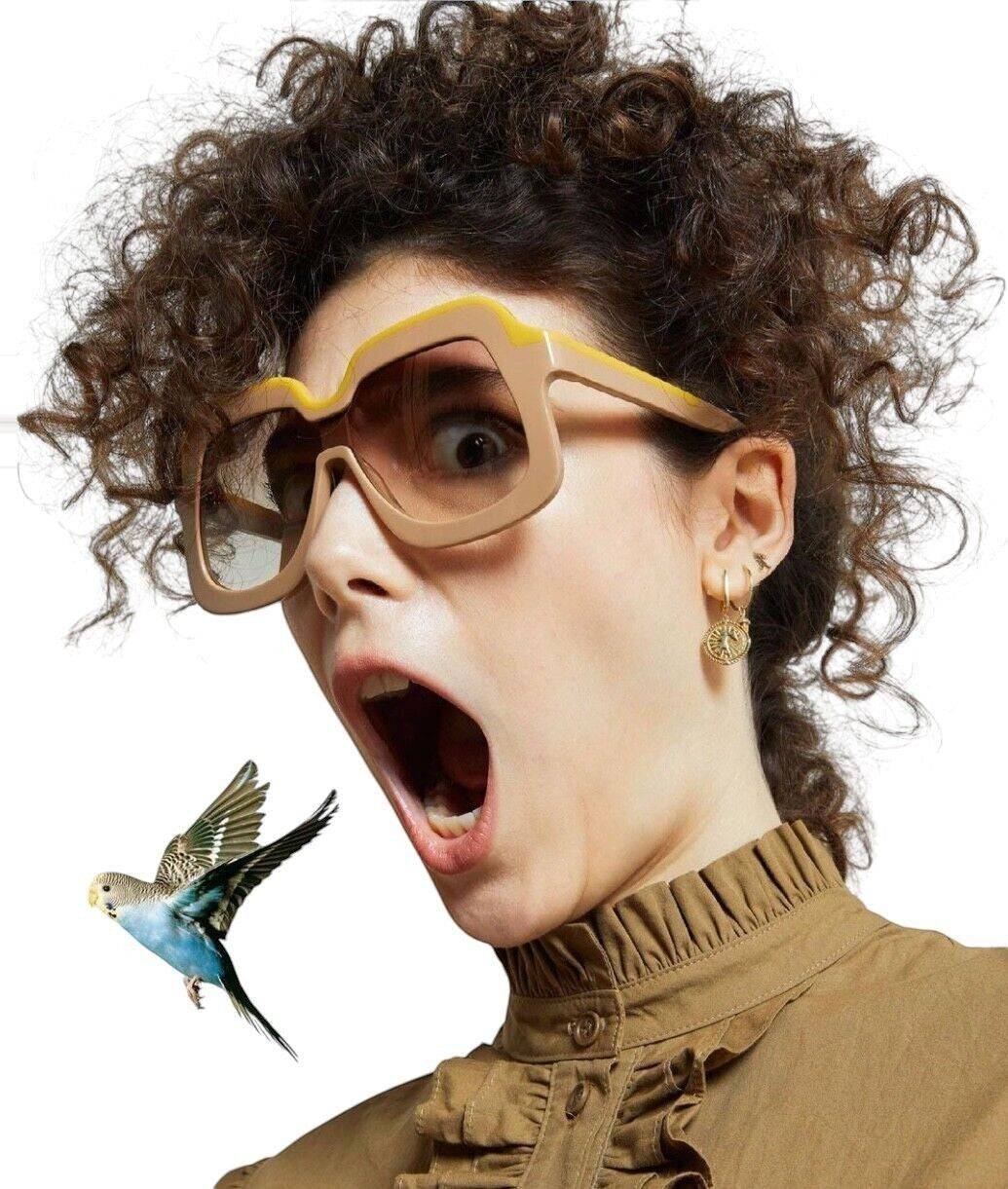 Naked Pear Karen Walker Overdaze sunglasses in crazy tortoise acetate with green lenses worn by a curly-haired model.