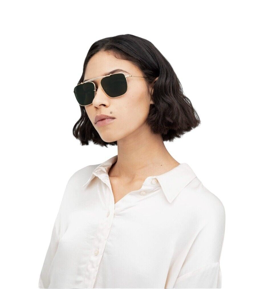 Model wearing Naked Pear Karen Walker Pampel gold aviator sunglasses with grass-green lenses and angled edges