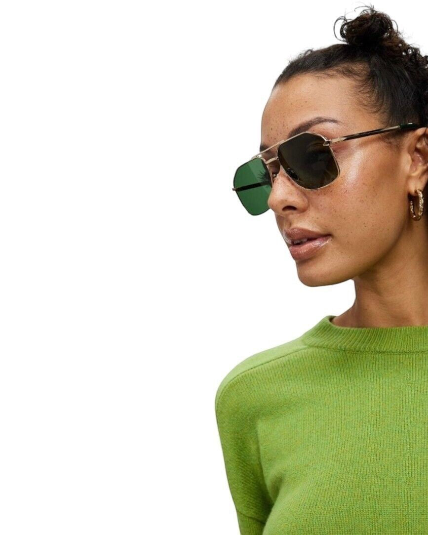 Naked Pear model wearing Karen Walker Pampel aviator sunglasses with gold frames and grass-green lenses