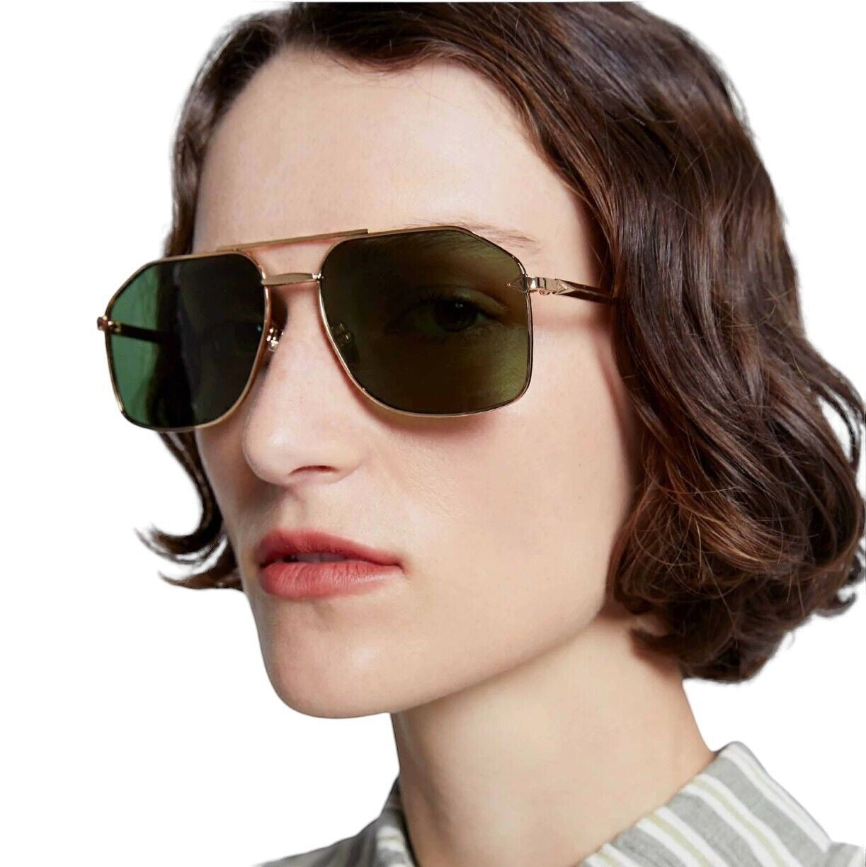 Model wearing Naked Pear Karen Walker Pampel aviator sunglasses with polished gold frames and grass-green lenses.