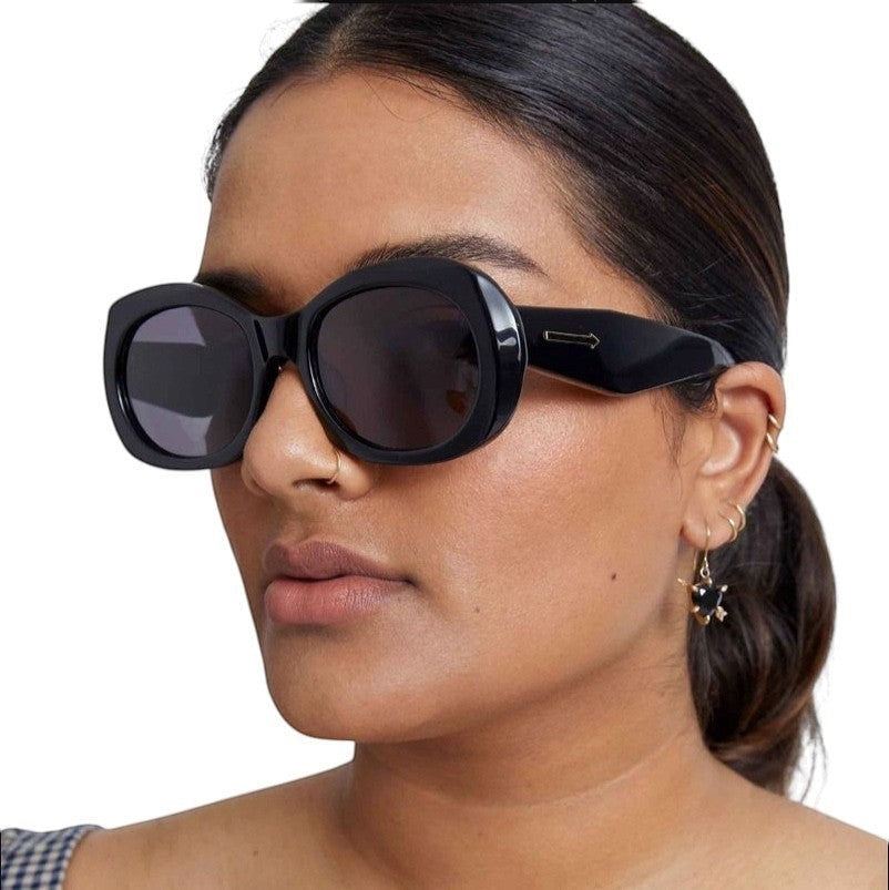 Naked Pear Karen Walker Parlour B oversized black oval acetate sunglasses with smoke lenses on a model