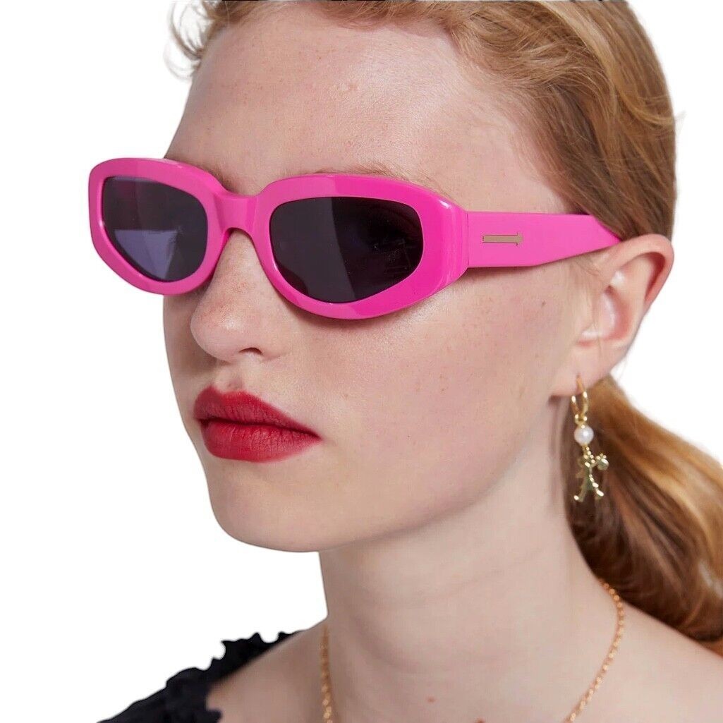Naked Pear Karen Walker Rally sunglasses in glossy fuchsia pink acetate with smoke grey lenses and gold arrow detail.