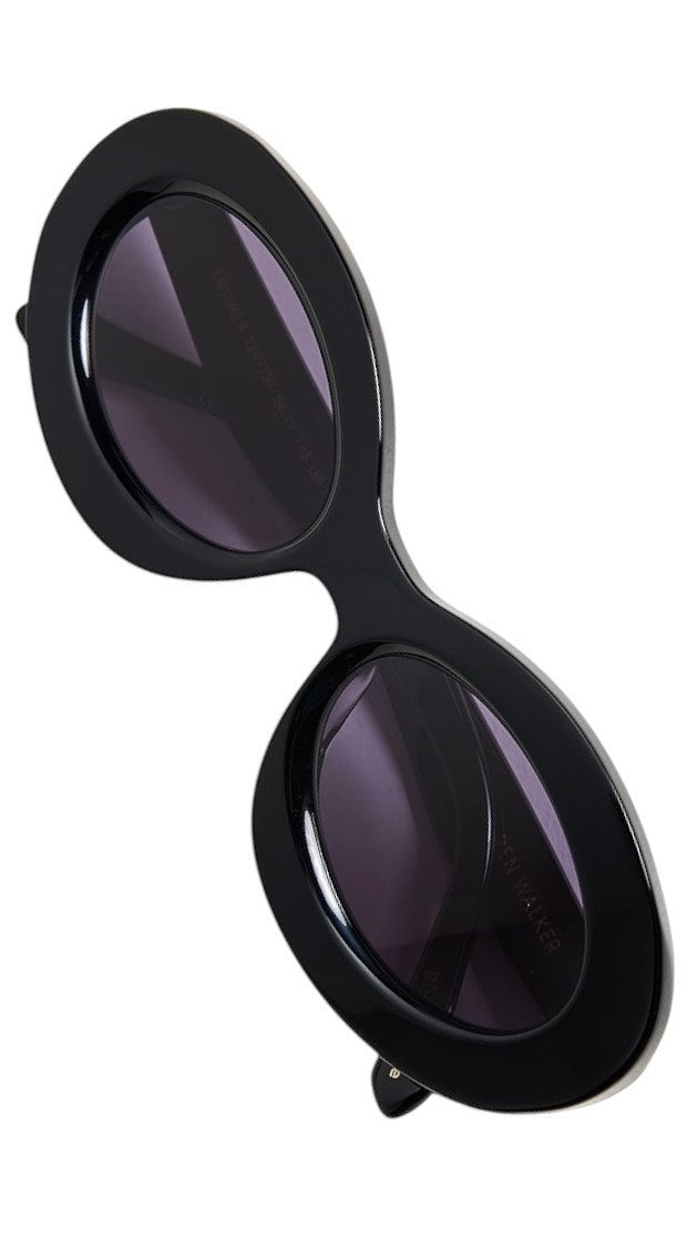 Naked Pear Karen Walker Rapture B black oval bio-acetate sunglasses with grey lenses and signature gold arrowhead