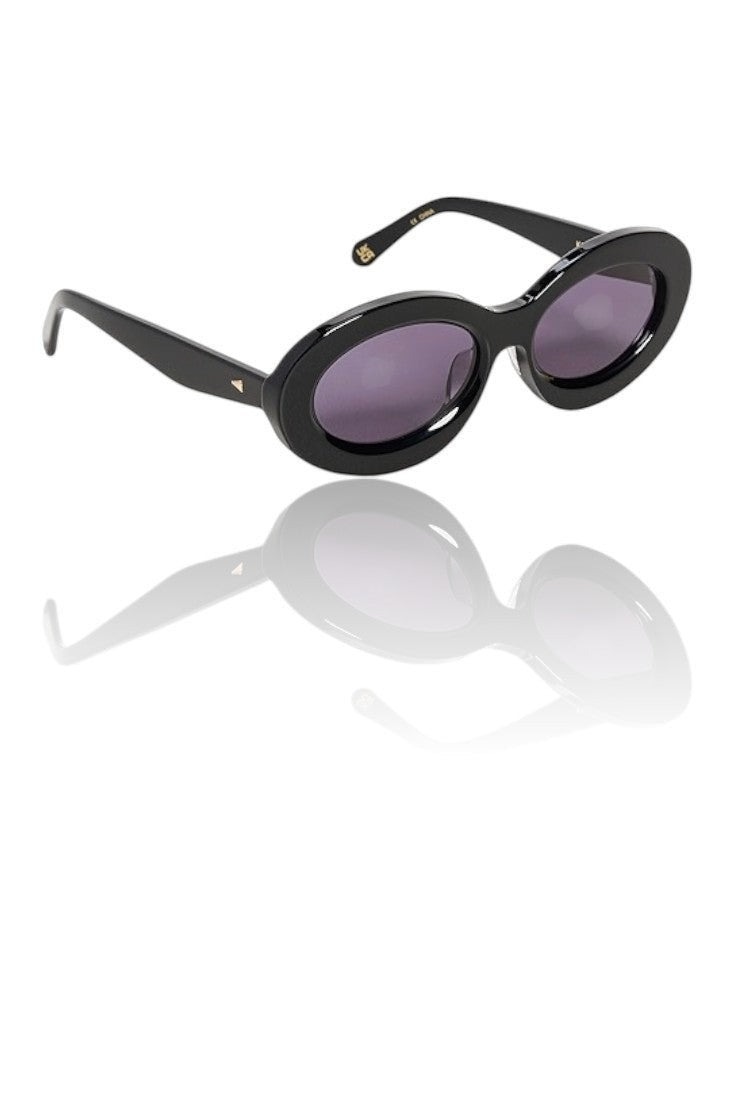 Naked Pear Karen Walker Rapture B oval sunglasses in black bio-acetate with grey lenses and gold arrowhead detail.