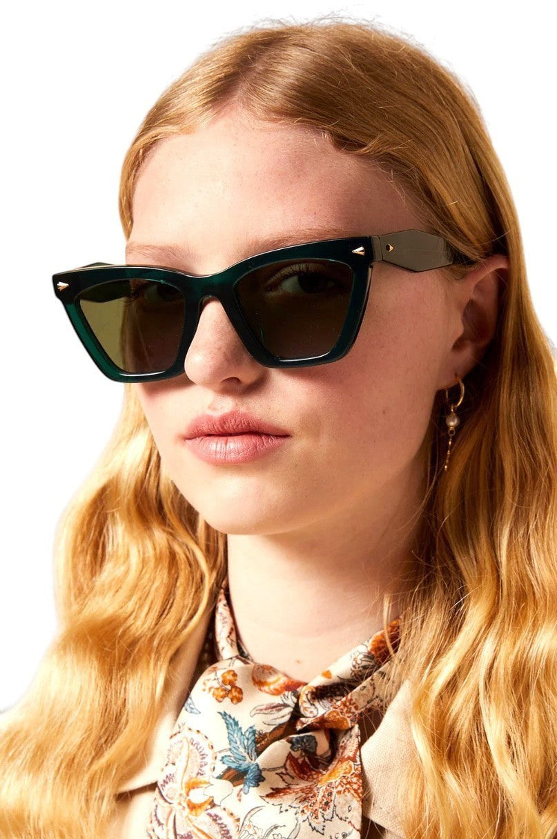 Naked Pear Karen Walker Spellbound emerald green cat-eye acetate sunglasses with gold arrow detail on a model