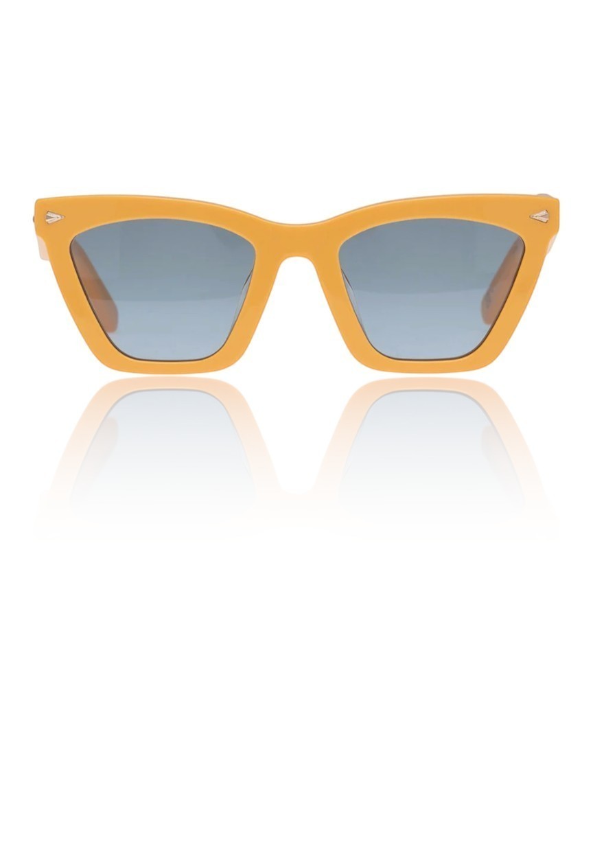Naked Pear Karen Walker Spellbound cat-eye sunglasses in marigold acetate with emerald-tinted lenses and gold arrows.