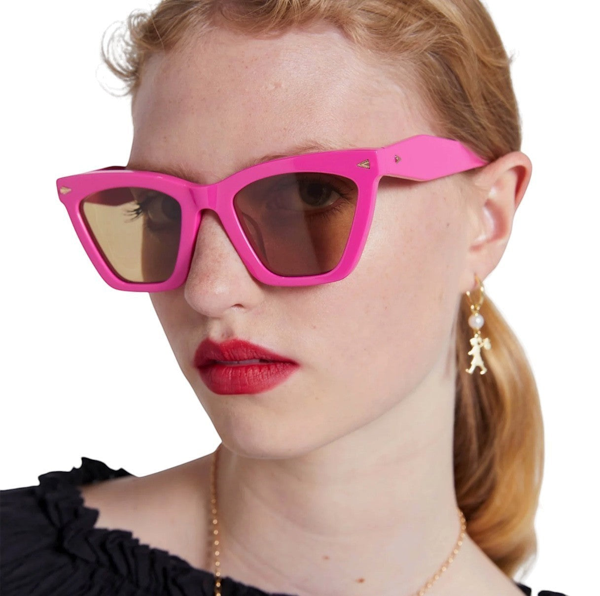 Naked Pear Karen Walker Spellbound cat-eye sunglasses in fuchsia acetate with brown lenses worn by a model